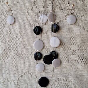 Black and White Beads on a beaded 3 stand wire.  White earrings to match